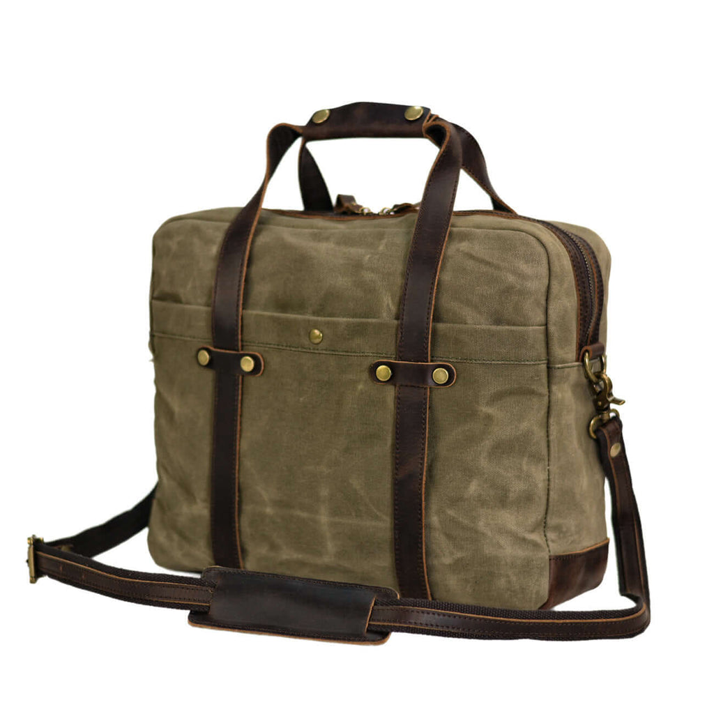 Angled view of vintage green canvas laptop bag with leather details