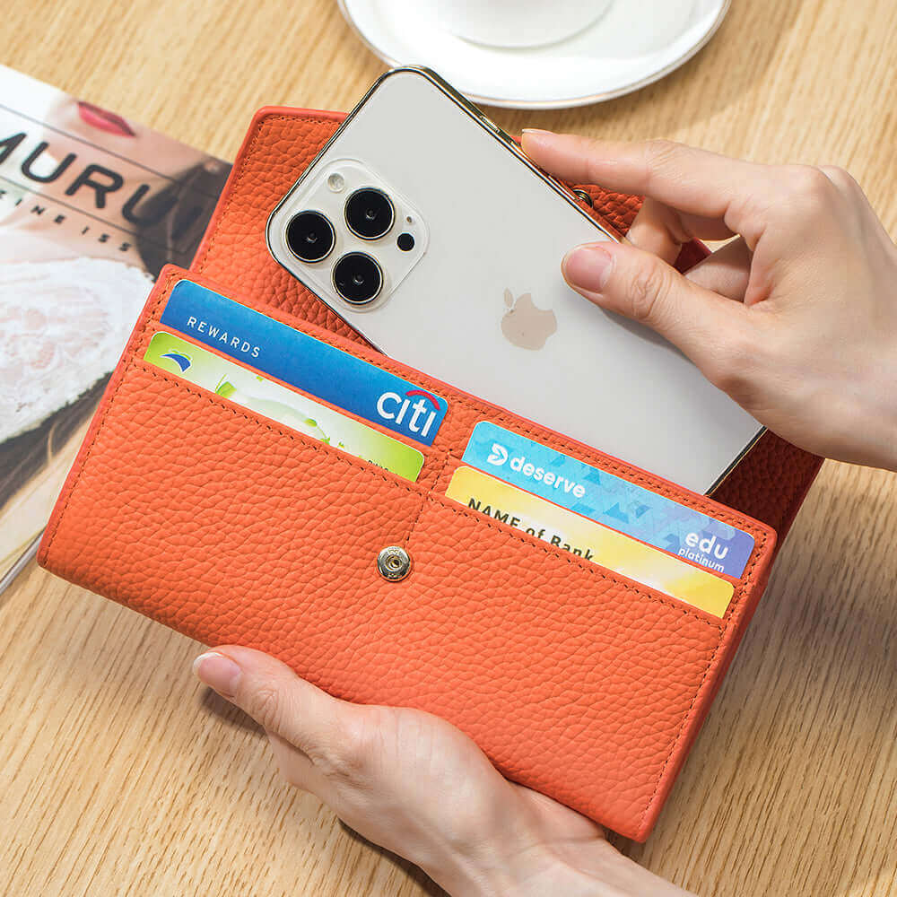 Open view of the Women's Leather Bifold Envelope Wallet in orange, displaying the interior compartments.