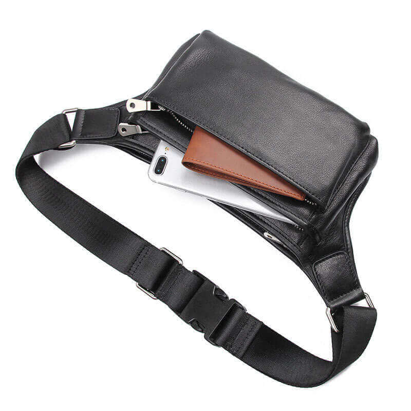 Adjustable strap on a black leather waist bag for multiple wearing options.