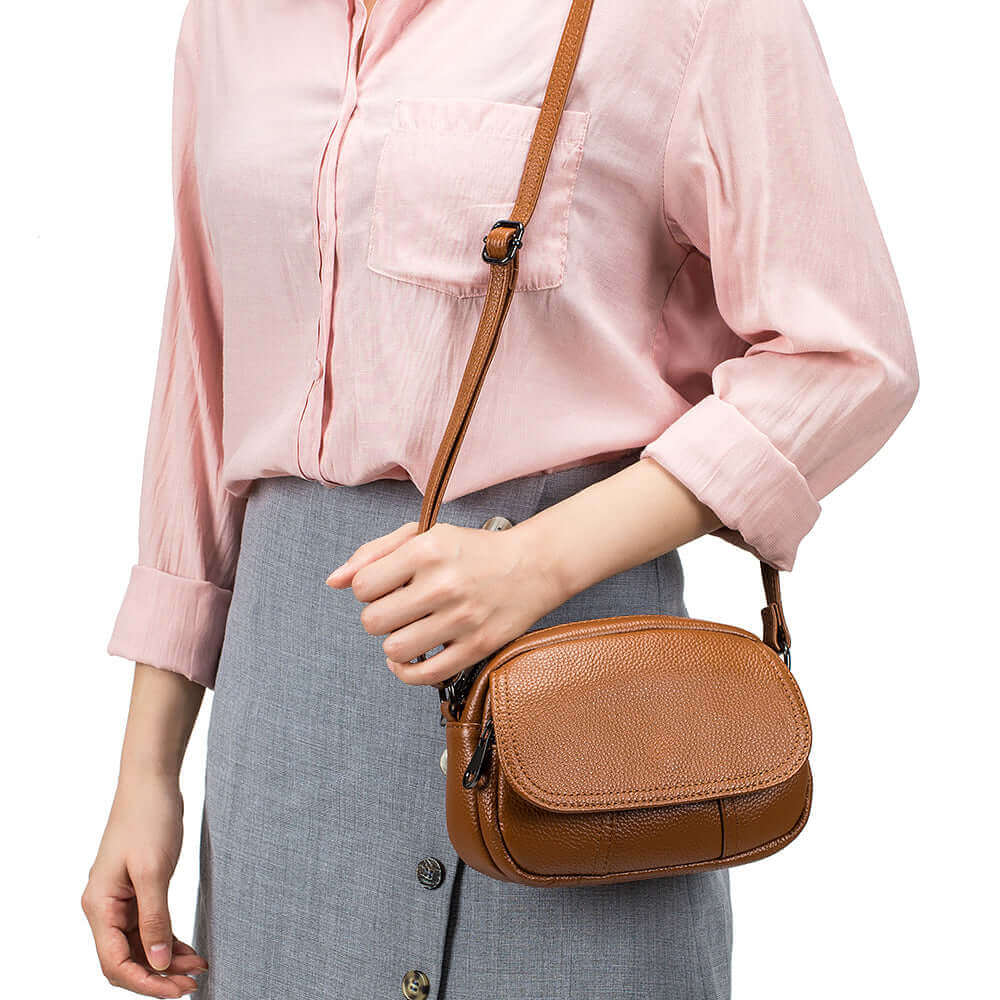 Genuine leather round bag with multiple pockets, offering style and practicality for everyday use.