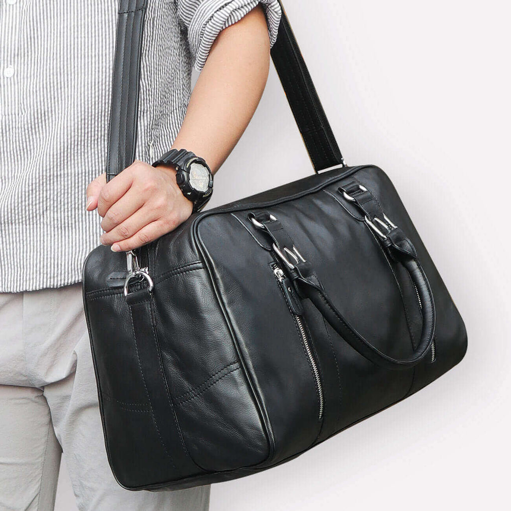 Genuine leather travel bag with spacious compartments for essentials.