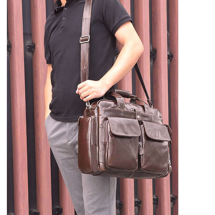 Man carrying the leather laptop bag crossbody style.