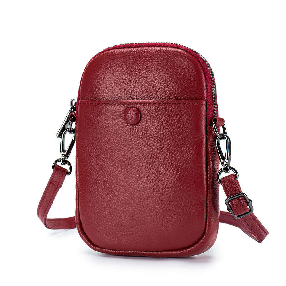 Mini leather crossbody phone bag with functional compartments for storing essentials.