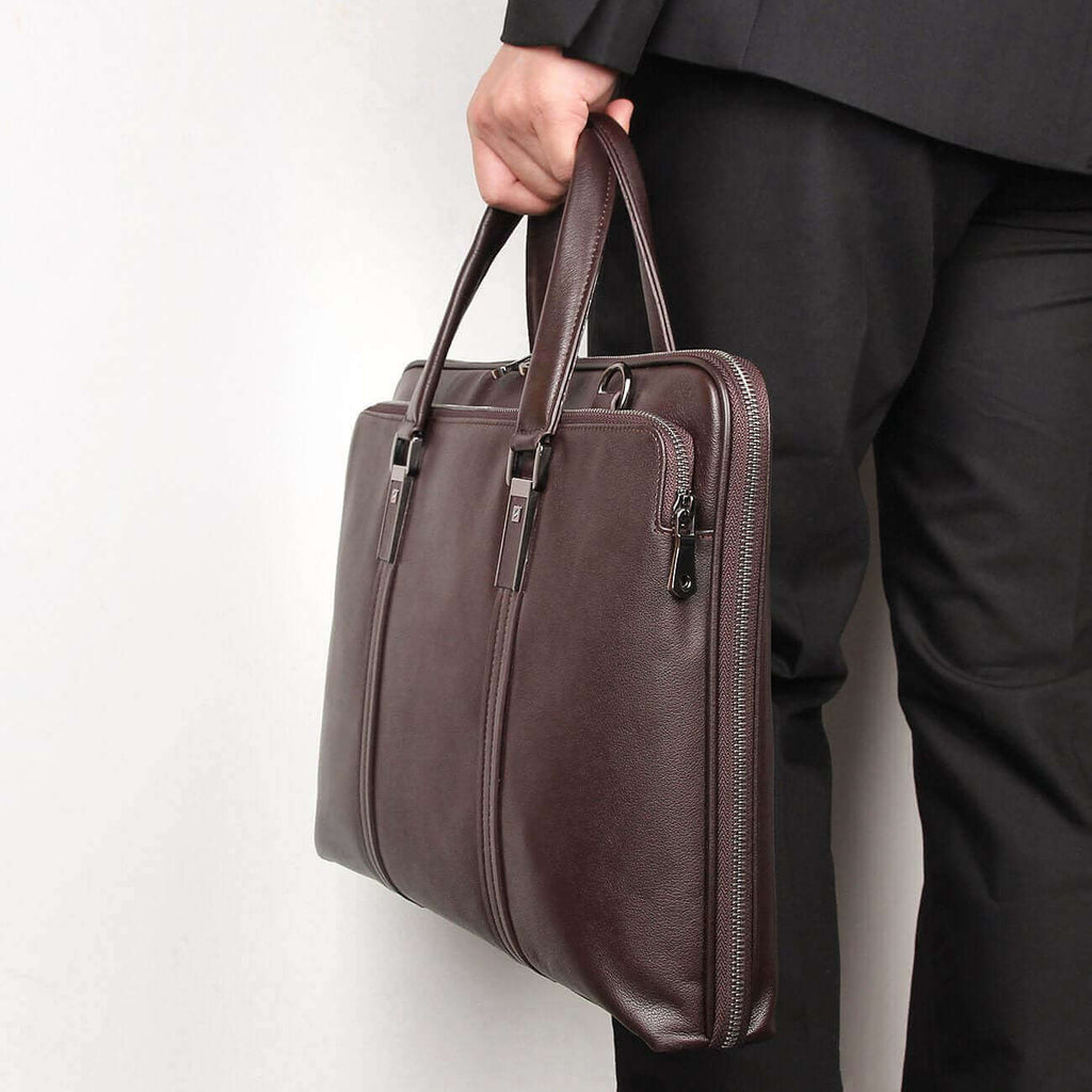 Slim leather laptop bag in a professional setting for daily work.