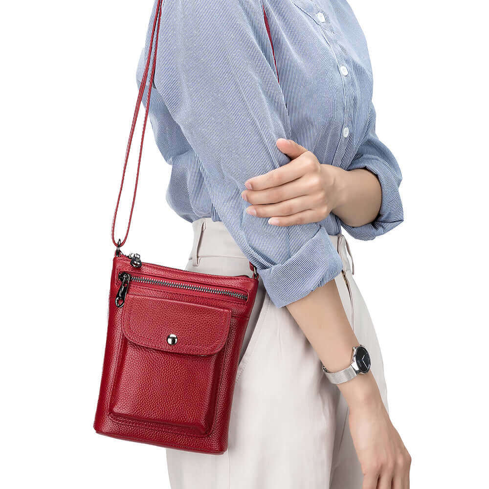 Stylish women's leather crossbody bag with sleek vertical design and multiple compartments.